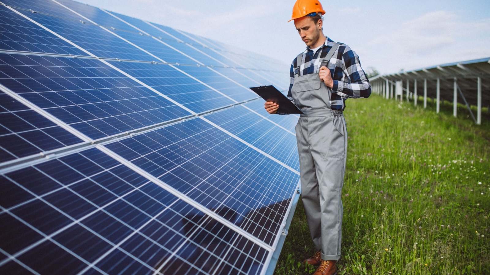 man-worker-firld-by-solar-panels-min
