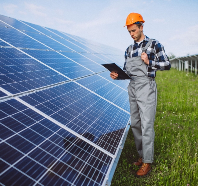 man-worker-firld-by-solar-panels-min