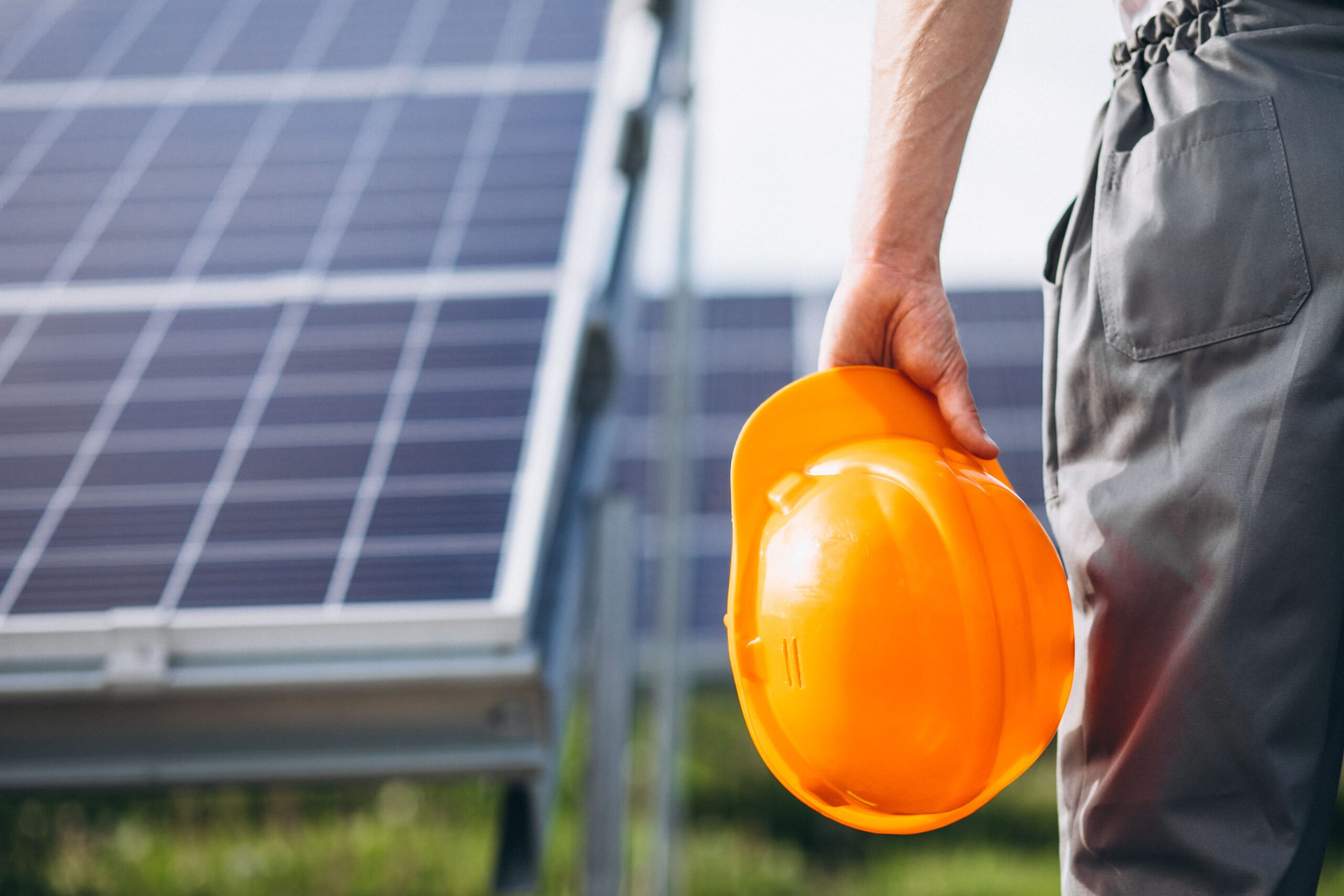 man-worker-firld-by-solar-panels-min